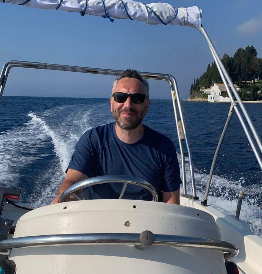 Mike Smalley, founder of X8 Drones, at the helm of a boat